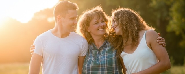 A family standing outdoors at sunset