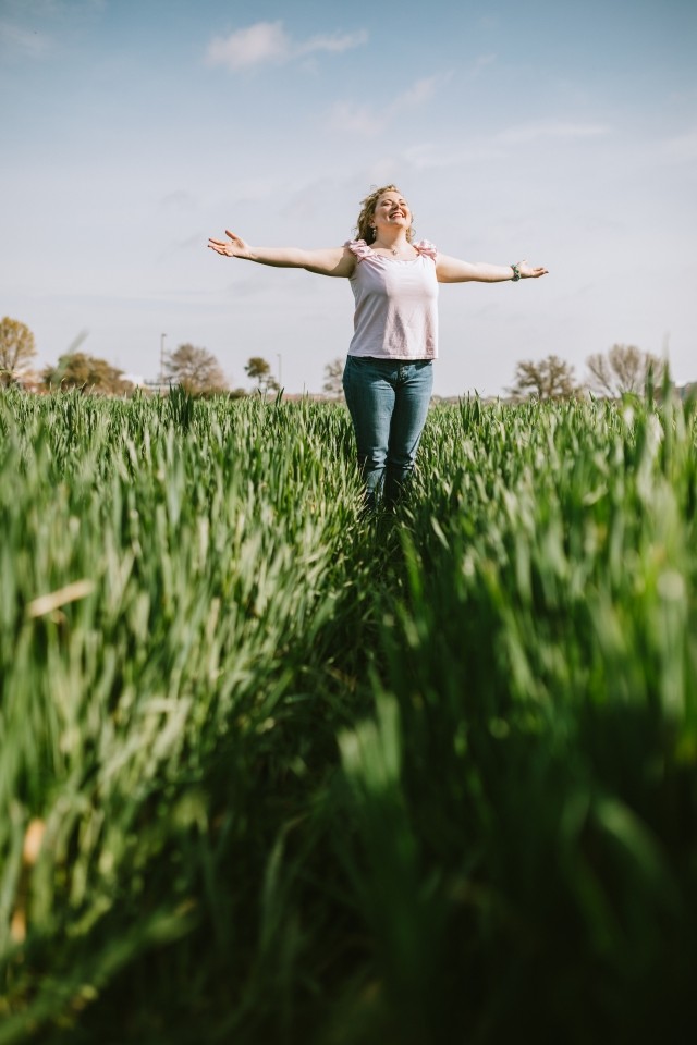 A woman is standing in a flower field